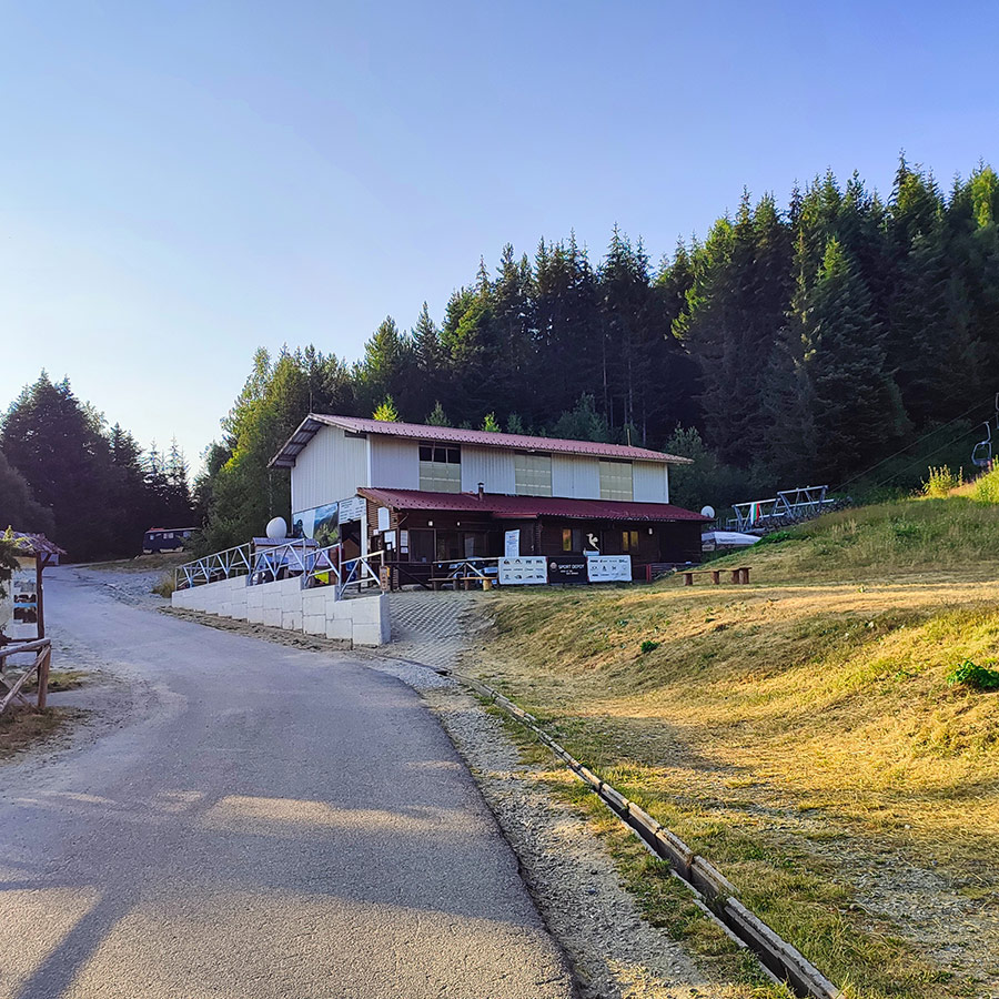 Base station of the Rila Lakes chairlift surrounded by pine forest in Bulgaria.