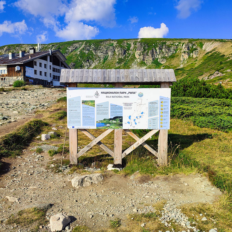 Information board with Seven Rila Lakes map near the mountain hut.