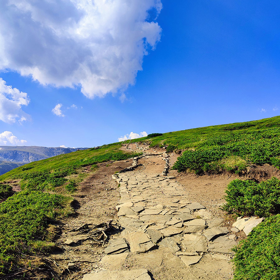 Stone-paved mountain trail climbing towards the Seven Rila Lakes plateau.
