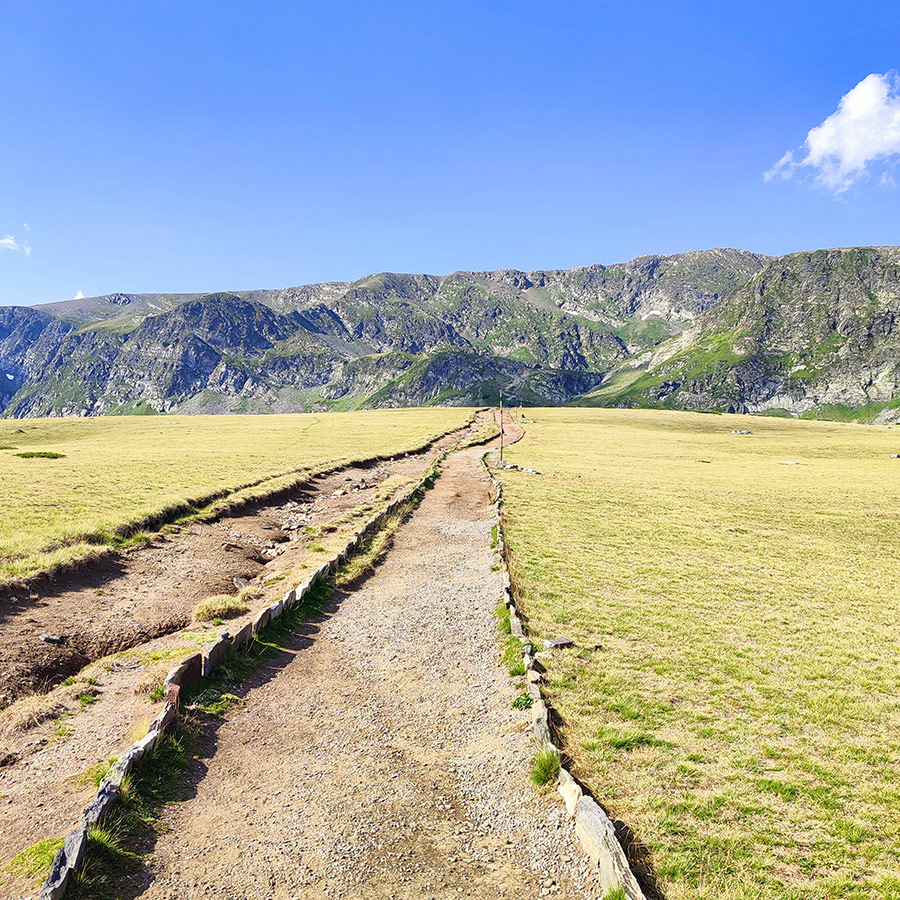 Hiking trail through alpine meadows in Rila Mountain, Bulgaria.