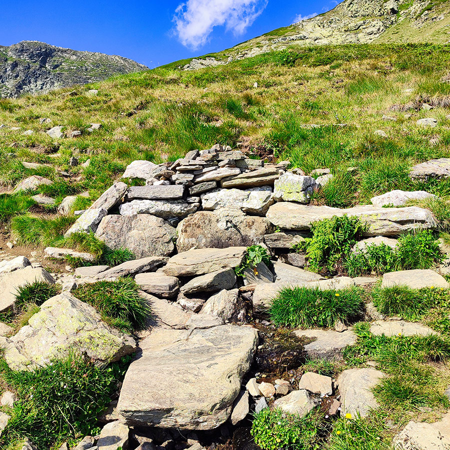 Small mountain spring with rocks on the trail to the Seven Rila Lakes, Bulgaria.