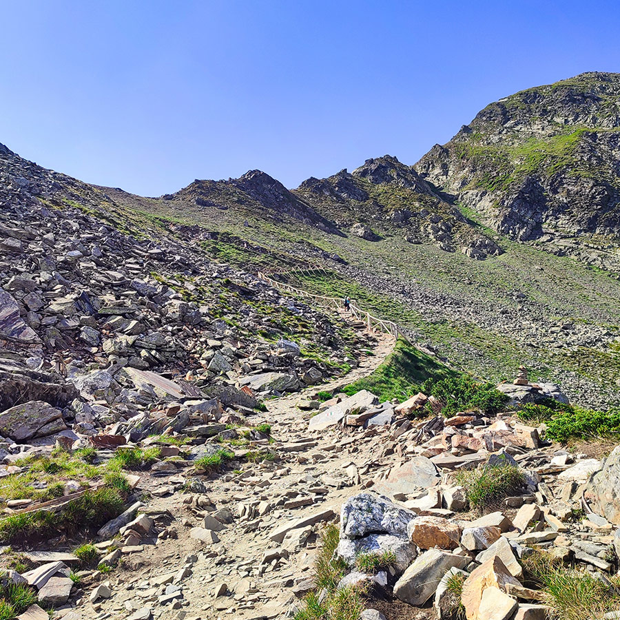 Rocky hiking trail surrounded by steep slopes in the Seven Rila Lakes, Bulgaria.