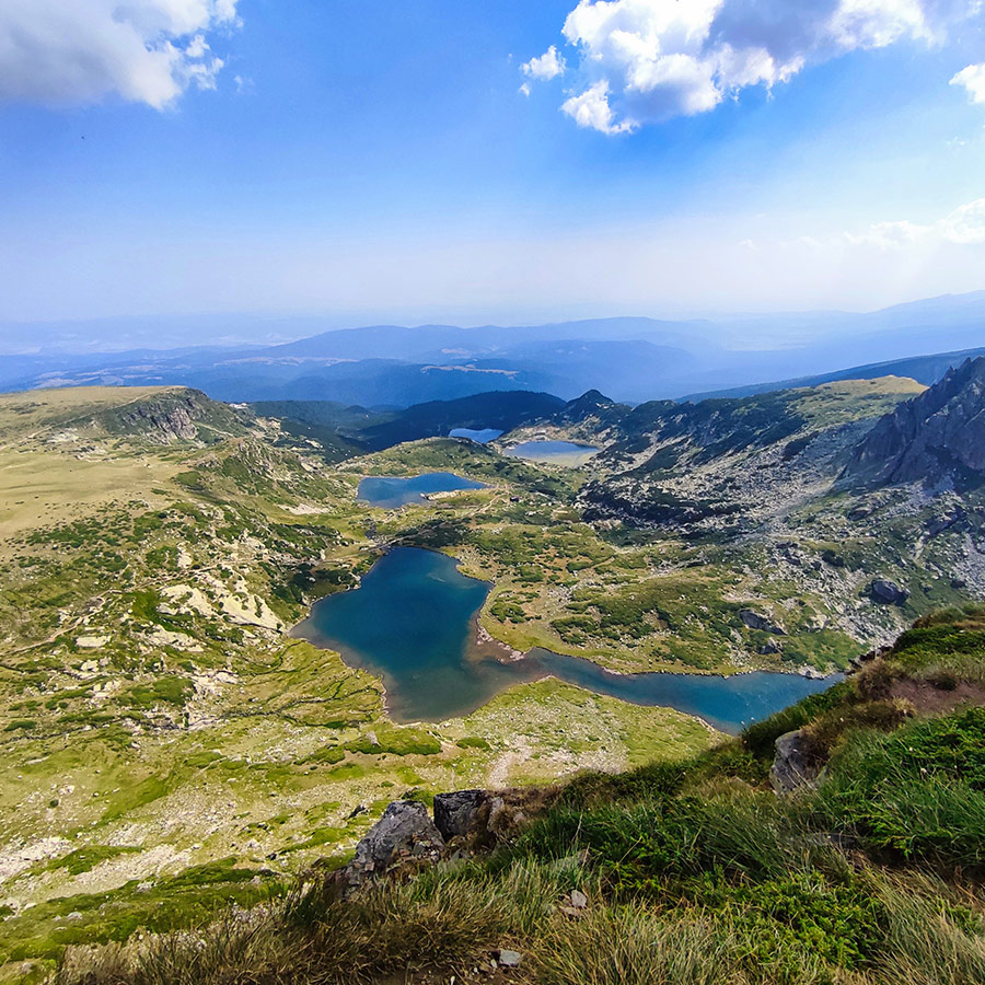 Scenic view of four of the Seven Rila Lakes stretching into the horizon.