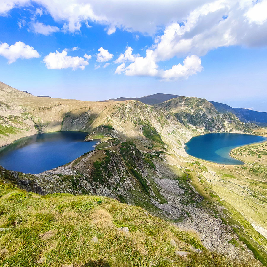 Twin alpine lakes of the Seven Rila Lakes with dramatic cliffs.