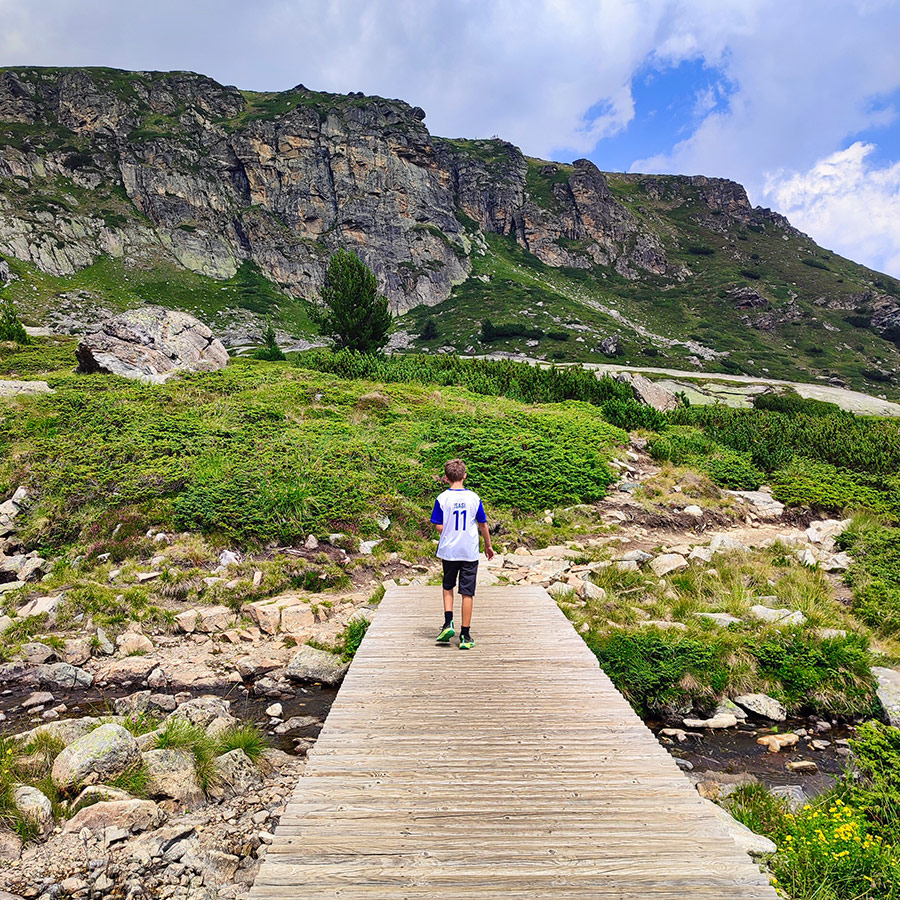 Wooden bridge crossing a mountain stream on the trail to the Seven Rila Lakes, Bulgaria.