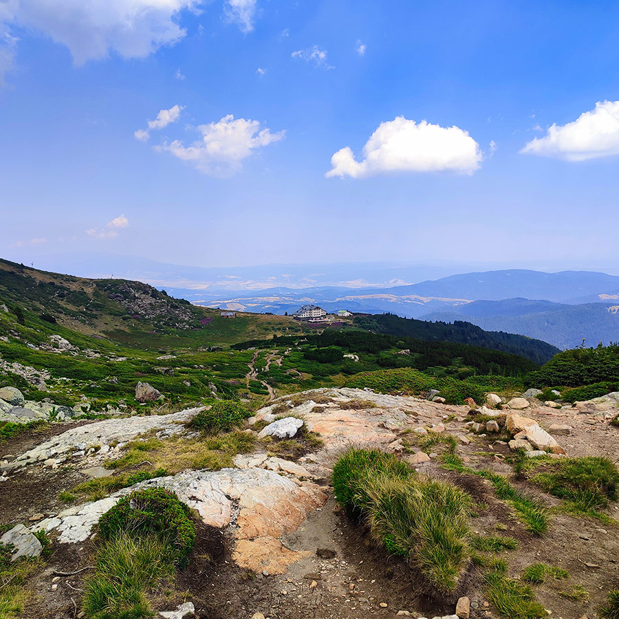 View from the trail towards Rila Lakes Hut with panoramic mountain landscapes.