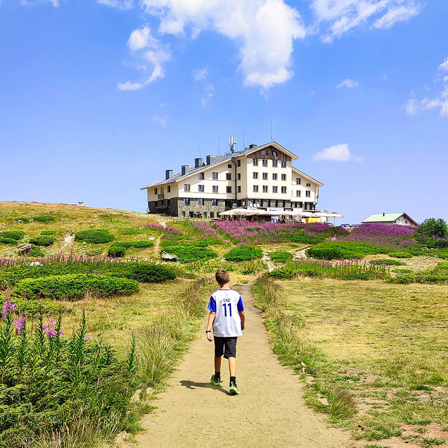 Rila Lakes Hut surrounded by alpine meadows, a starting point for the Seven Rila Lakes hike.