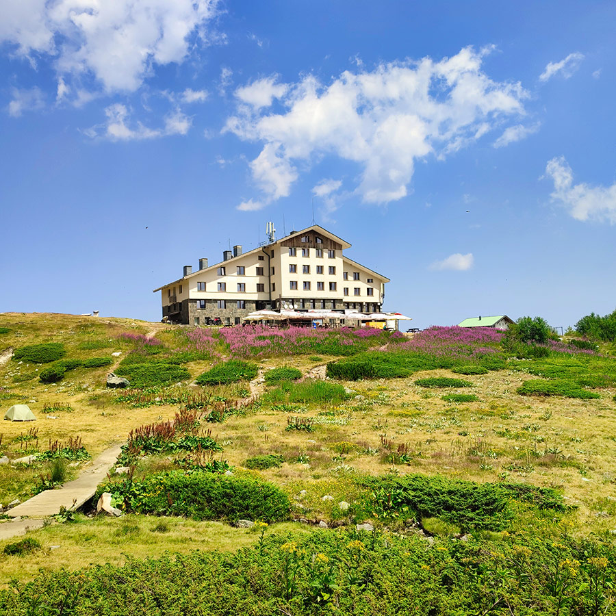 Rila Lakes Hut surrounded by alpine meadows, a starting point for the Seven Rila Lakes hike.
