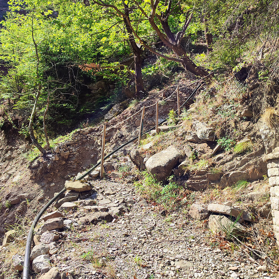 Rocky hiking path with wooden fence near Anthochori Waterfall, Agrafa, Karditsa, Greece