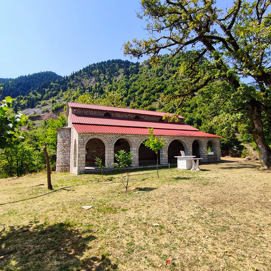Stone church with red roof in Anthochori village, Agrafa, Karditsa, Greece