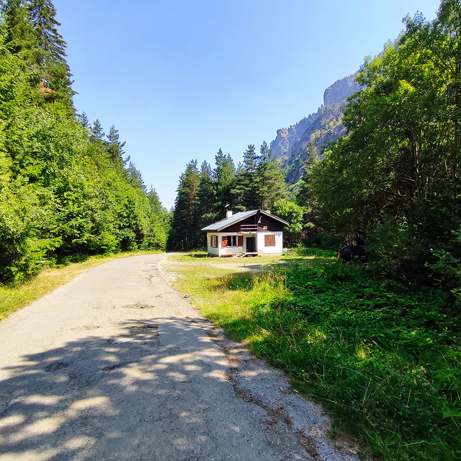 Mountain hut surrounded by pine forest near the entrance of the Beli Iskar Eco Trail in Rila Mountain, Bulgaria.