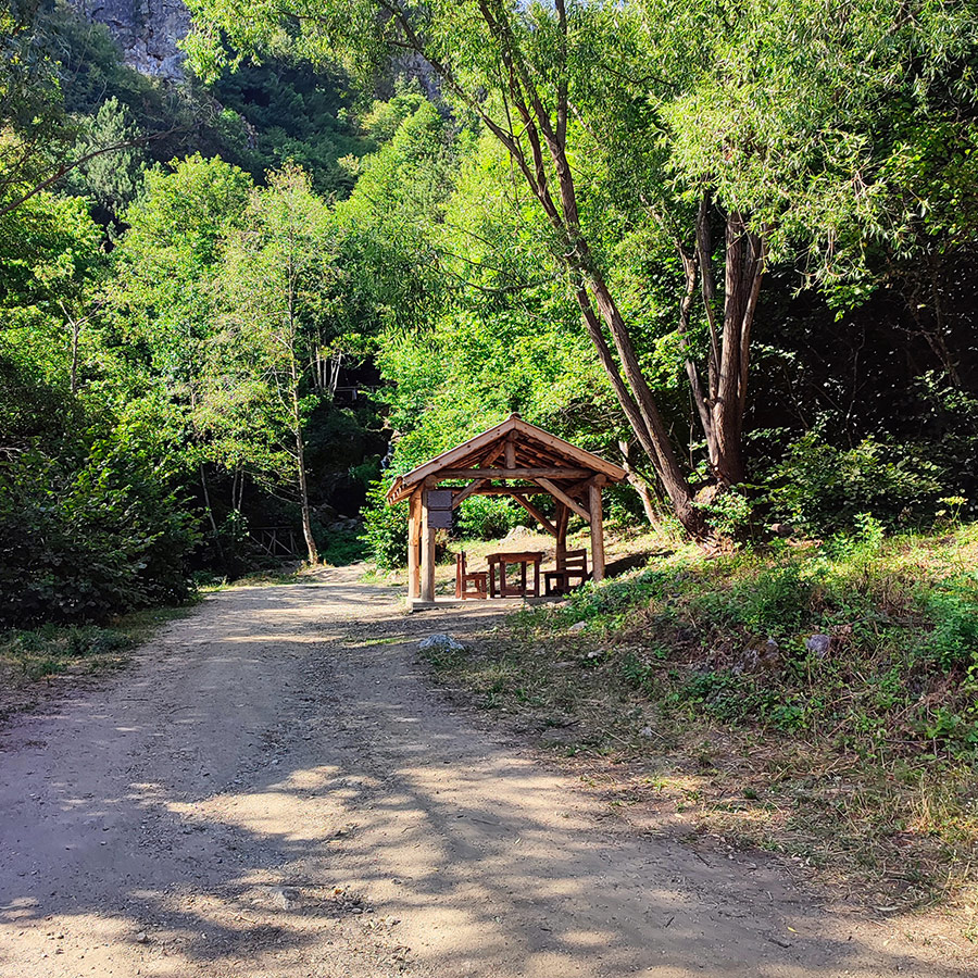 Wooden shelter and resting area at the trailhead to Saint Nicholas Waterfall near Bansko, Bulgaria.