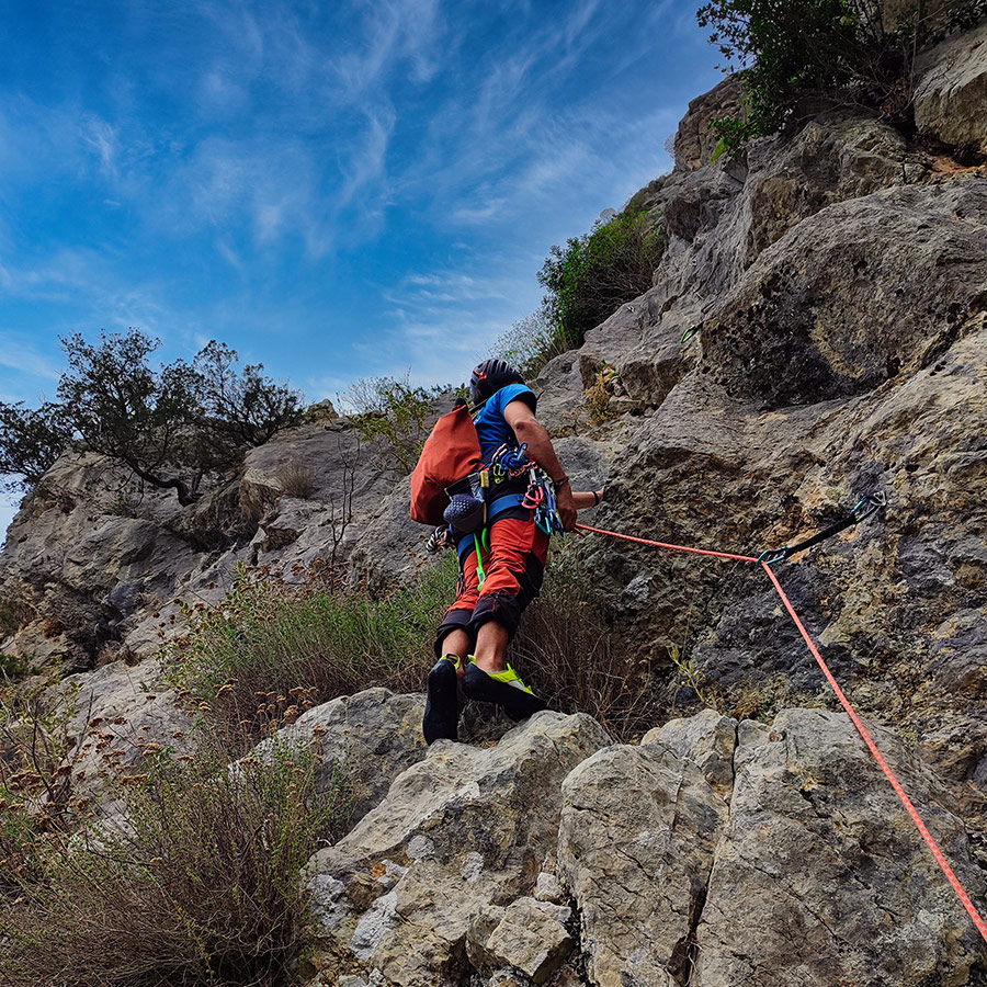 Lead climber starting the first pitch of Asterope multi-pitch climb on Pleiades Crag, Ermioni.