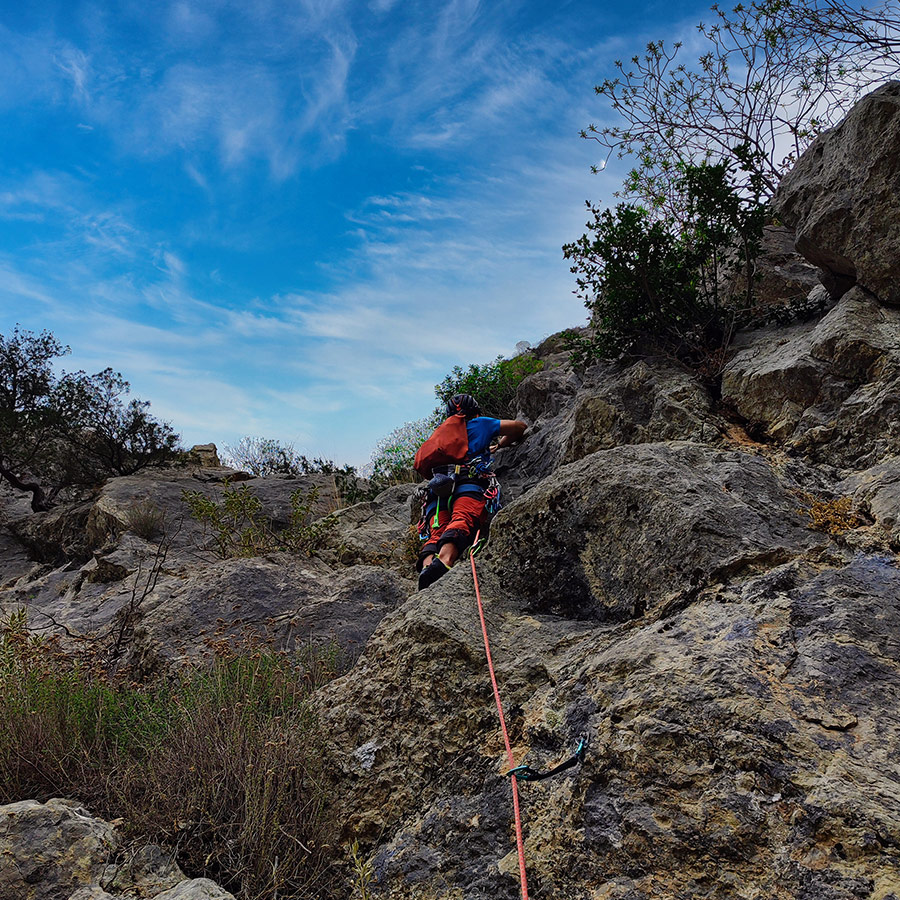 Lead climber ascending the lower section of the Asterope multi-pitch route on Pleiades Crag.