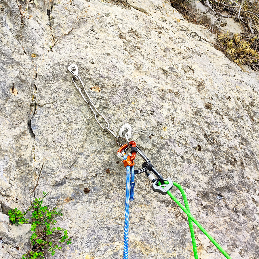 Stainless-steel bolted belay anchor with chains on Asterope route in Katafyki Gorge.