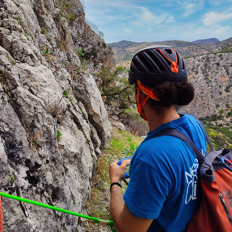 Climber at belay stance overlooking Katafyki Gorge during the Asterope climb.