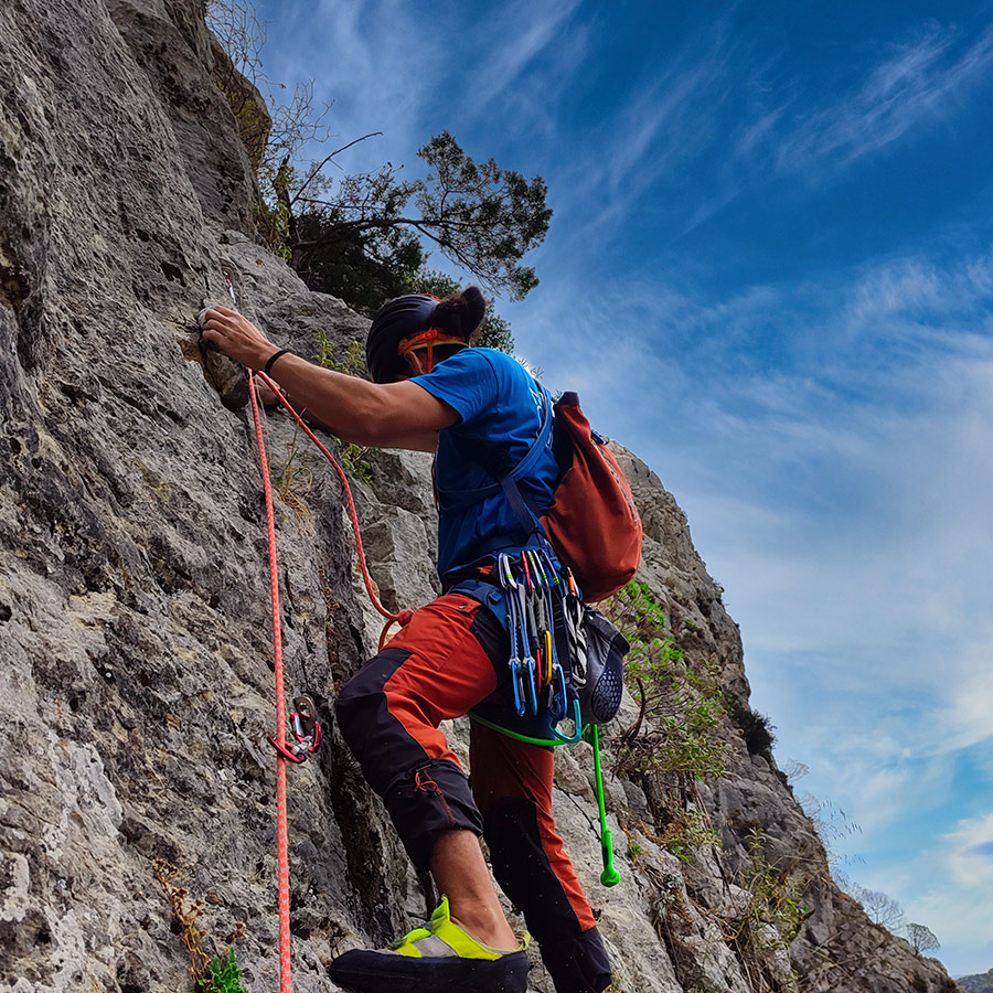 Climber balancing on small holds on Asterope’s technical slab section.