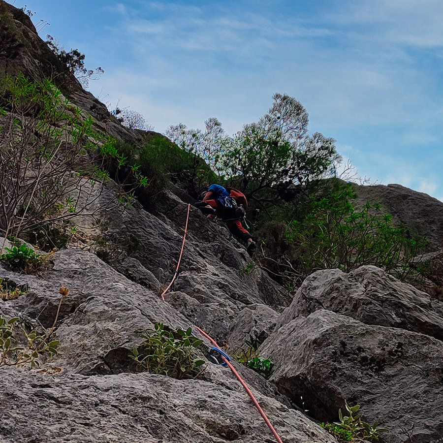 Lead climber nearing the belay of Asterope’s upper pitch with rope extended below.