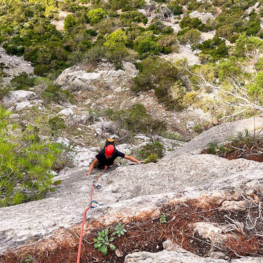 Second climber following the steep wall of Asterope route on Pleiades Crag, Ermioni.