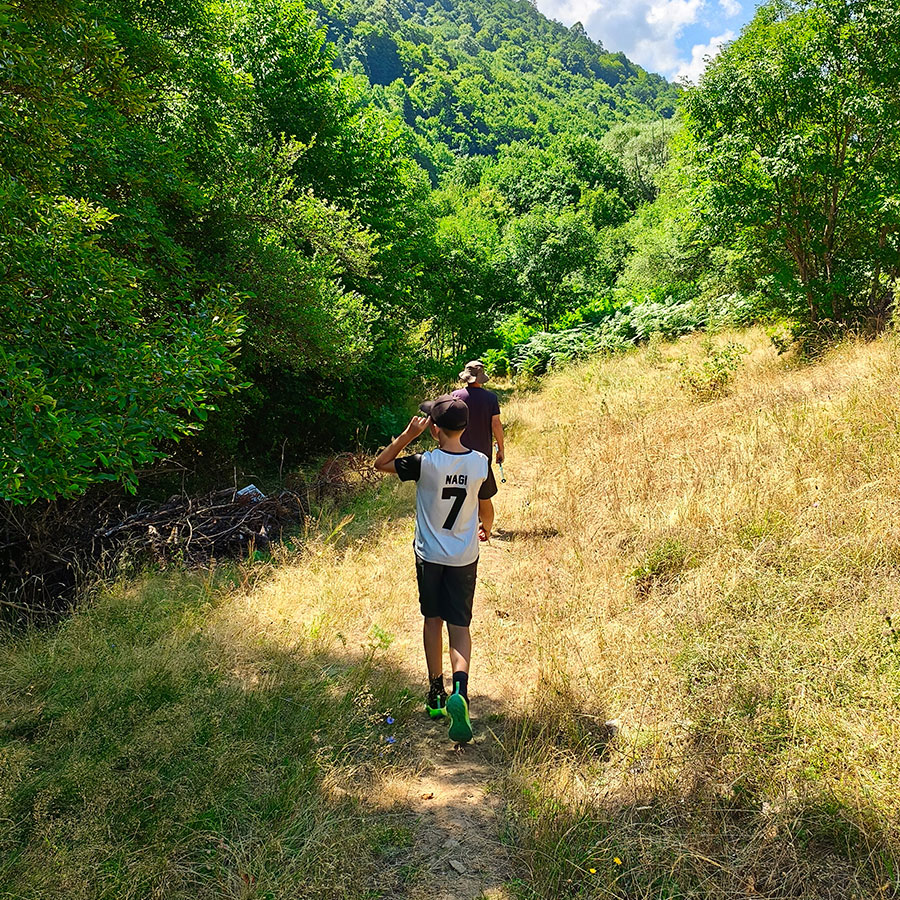Hiking through the forest trail towards Kapejnci Waterfall near Dihovo