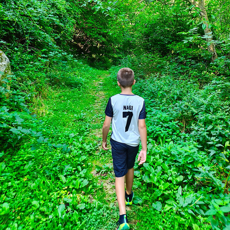 Hiker walking through the forest trail to Vistinski Vir Waterfall
