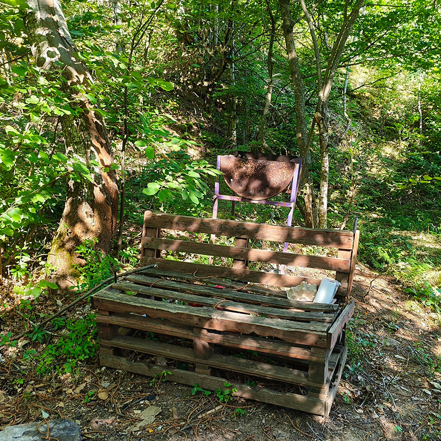 Rustic wooden bench along the hiking trail to Vistinski Vir Waterfall